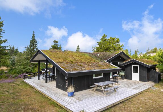 Indbydende træsommerhus med 3 terrasser og sauna